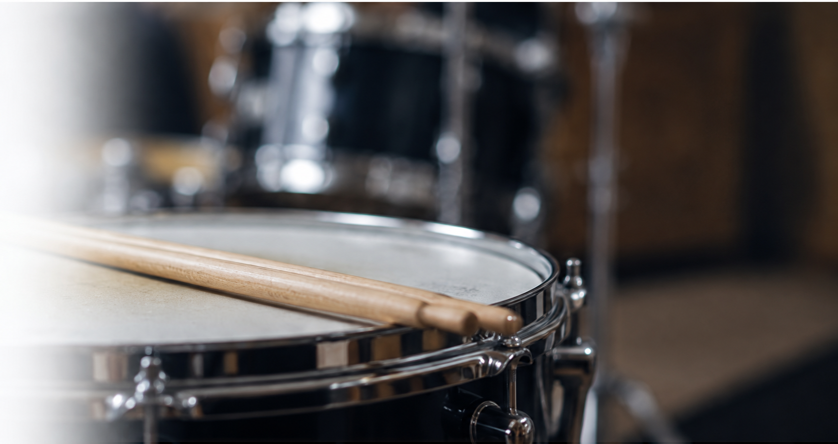 Drumsticks resting on a drum